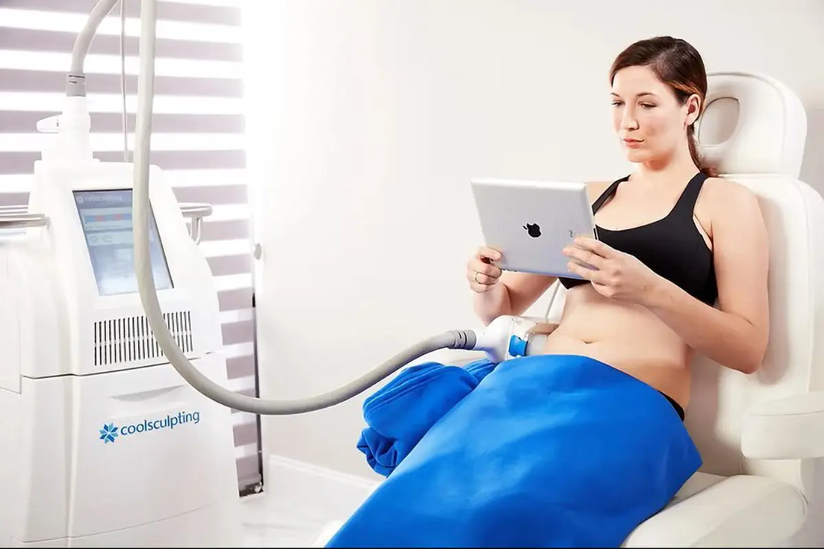 female patient on an ipad while on coolsculpting treatment female patient on an ipad while on coolsculpting treatment
